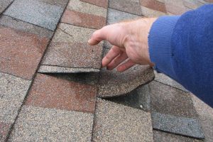 Roof shingles damaged by spring storms