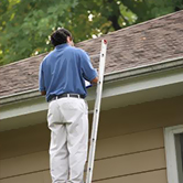An employee with Xtreme Home Improvement inspects a roof