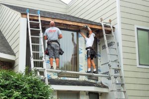 Xtreme Home Improvement technicians repair hail damage to a home